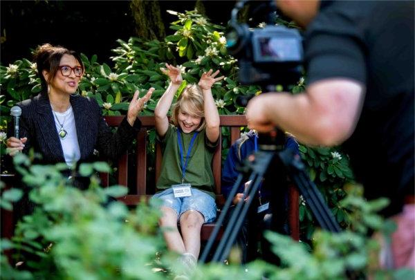 Grand Rapids Christian Elementary - Evergreen student Will Mulder jokes with WGVU's Jennifer Moss while being interviewed about their student project during the Groundswell Stewardship Initiative student project showcase on the Pew Grand Rapids Campus May 15.