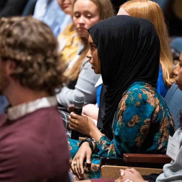 Student with the Cook Leadership Academy asks a question during alumni panel