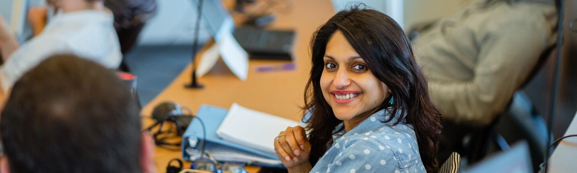 Business student sitting at a classroom desk.